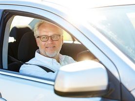 Older man with glasses driving.jpeg